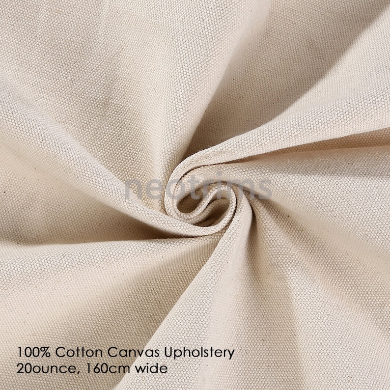 May include: Close-up of a natural-colored cotton canvas fabric. The fabric is woven with a tight weave and has a smooth, even texture. 100% Cotton Canvas Upholstery 20 ounce, 160cm wide