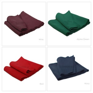 May include: Four folded pool table cloth samples in different colors: wine, alpine green, red, and navy.