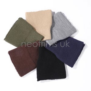 May include: A collection of seven knitted beanies in various colors, including olive green, tan, gray, navy, black, and burgundy. The beanies are arranged in a circular pattern on a white background. The text "neotrims uk" is visible.