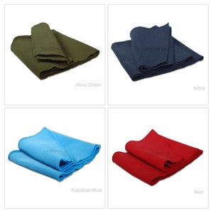 May include: Four fabric swatches in different colors: moss green, navy blue, porcelain blue, and red. Each swatch is folded in thirds and has the text "neotrims.uk" printed on it.