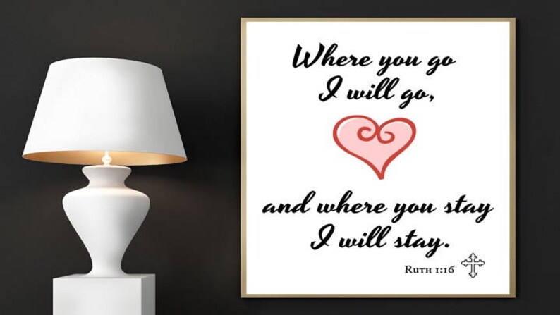 May include: A white framed print with a black heart and the text "Where you go I will go, and where you stay I will stay."  The text is in a cursive font.  The bottom of the print has the text "Ruth 1:16" and a small cross.