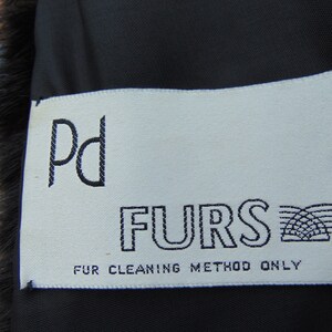 May include: White tag with black text that reads "Pd FURS" and "FUR CLEANING METHOD ONLY".
