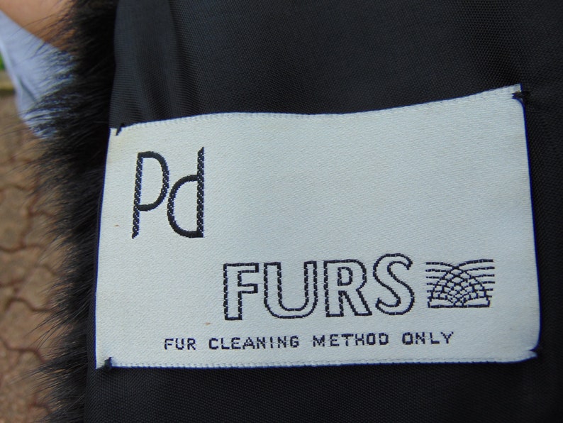 May include: White tag with black text that reads "Pd FURS" and "FUR CLEANING METHOD ONLY".
