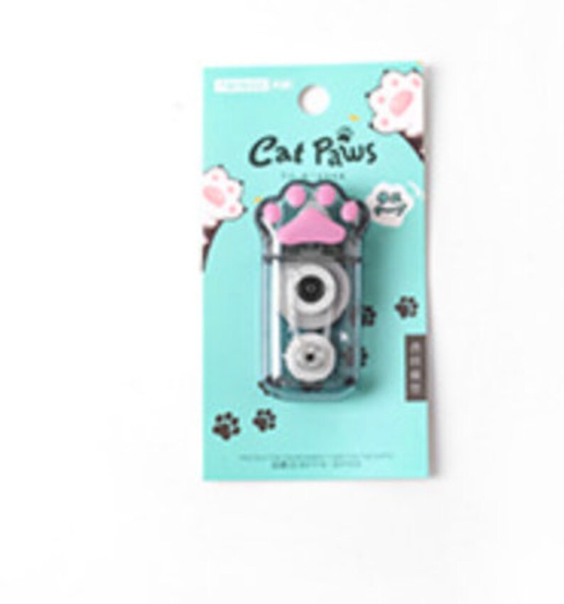 May include: A blue and pink tape dispenser with a cat paw design. The dispenser has a clear plastic body and a pink paw-shaped button. The text "Cat Paws" is printed on the front of the dispenser.