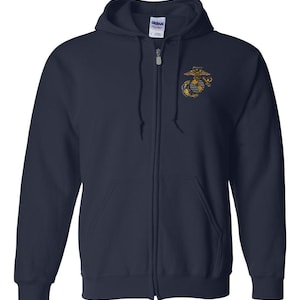 May include: Navy blue zip-up hooded sweatshirt with a gold and yellow emblem on the upper left chest. The sweatshirt has a drawstring hood and two front pockets. The brand name "Gildan" is visible on the tag.