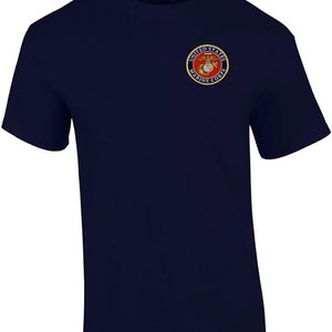 May include: A navy blue t-shirt with the United States Marine Corps logo embroidered on the left chest. The logo is red, yellow, and white.