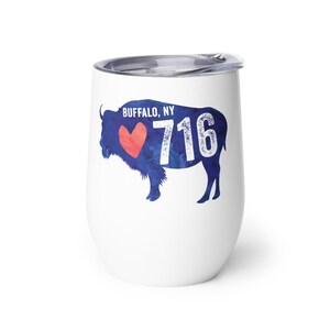 May include: White stainless steel wine tumbler with a blue watercolor silhouette of a buffalo with a red heart and the text "BUFFALO, NY 716".