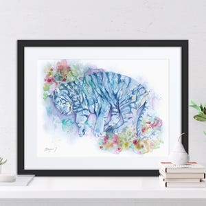 a framed watercolor painting of a tiger, with a black border and a white background.