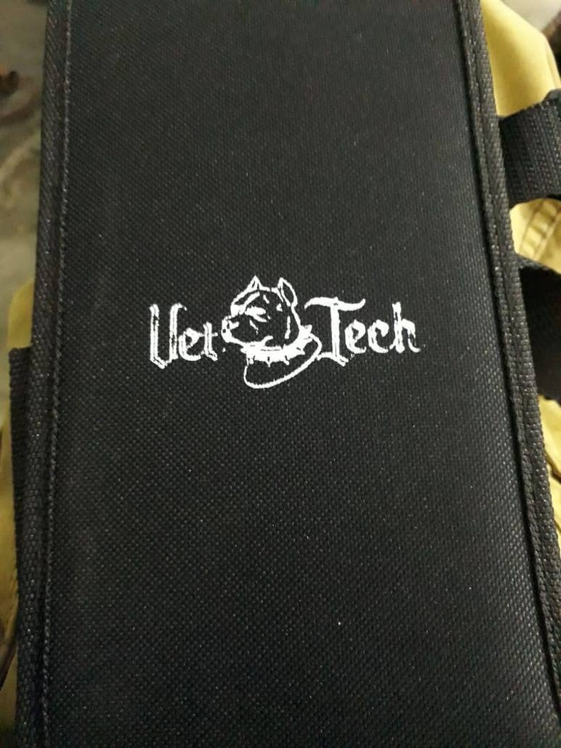 May include: Black canvas tool bag with a white logo that says "Vet Tech" and a white silhouette of a dog's head wearing a collar.