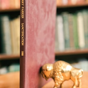 May include: A burgundy hardcover book with gold lettering on the spine that reads "Barry Parker Sanctification 1980".