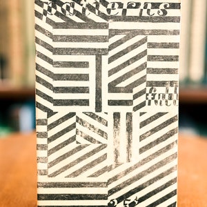 May include: A black and white book cover with the word "patterns" printed in bold, black letters. The cover features a geometric pattern of black and white stripes.