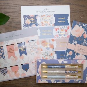 May include: A set of blue and pink floral themed stationery items including sticky notes, pens, bookmarks, and planner stickers. The items feature the text "Chosen & Cherished" and "Selah Sticky Notes".