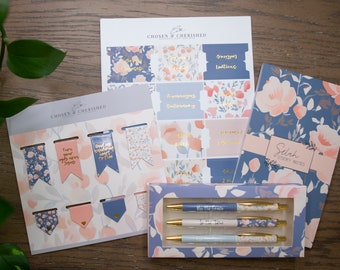 May include: A set of blue and pink floral themed stationery items including sticky notes, pens, bookmarks, and planner stickers. The items feature the text "Chosen & Cherished" and "Selah Sticky Notes".