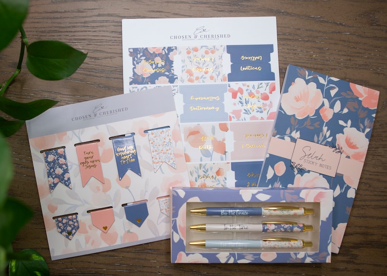 May include: A set of blue and pink floral themed stationery items including sticky notes, pens, bookmarks, and planner stickers. The items feature the text "Chosen & Cherished" and "Selah Sticky Notes".