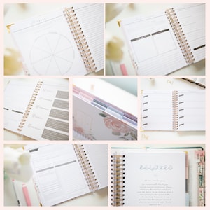 May include: A spiral-bound planner featuring white pages with black text, gold-toned wire binding, and floral-patterned dividers. The layout includes goal-setting sections, a life wheel diagram, daily reflection prompts, and tabbed dividers.