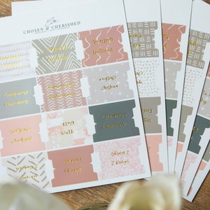 May include: A set of printable labels with different patterns and gold lettering. The labels are for organizing items such as "Soup", "Breakfast", "Bath", "Snacks", and "Clothes".