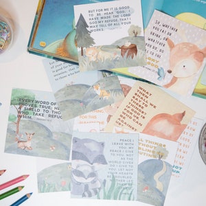 May include: A set of colorful illustrated cards with bible verses and animal illustrations. The cards feature a variety of animals, including a fox, a deer, a raccoon, and a bird. The verses are printed in a clear, easy-to-read font.