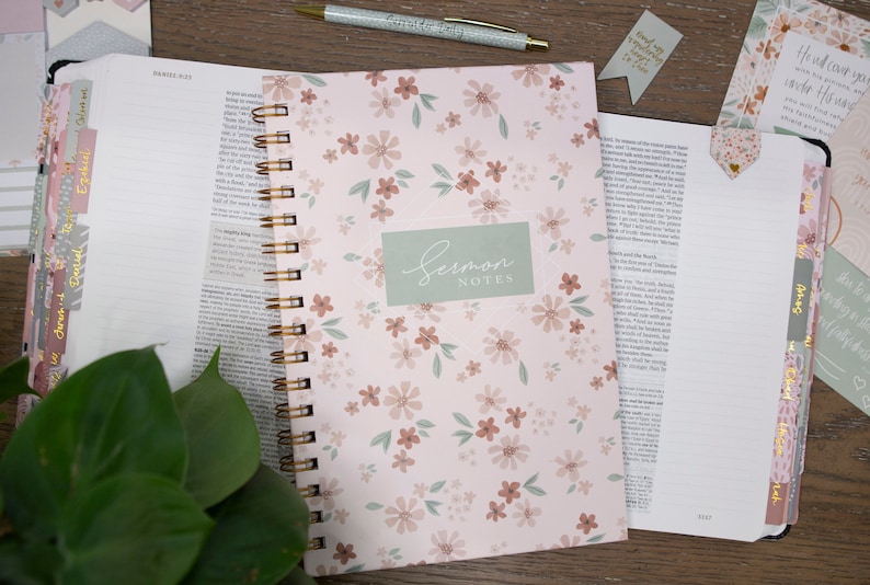 sermon-notes-journal-for-women-to-take-church-notes-with-floral-hardcover-sitting-on-bible-with-matching-floral-and-green-bible-tabs