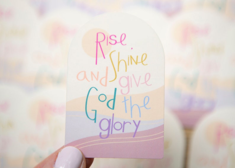 May include: A pink, white, and blue sticker with the text "Rise and shine and give God the glory".