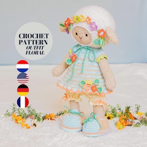 May include: Crochet pattern for a floral outfit for a sheep doll. The doll is wearing a light blue and yellow striped dress with a white crocheted flower crown. The doll is standing on a white fluffy surface with yellow flowers.