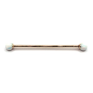 May include: Gold barbell with opal ends. The barbell is a straight piece of metal with rounded ends. The opal ends are white with a slight iridescent sheen.