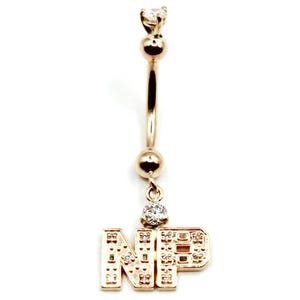 May include: Gold belly button ring with a dangling charm that says "NP" with clear cubic zirconia stones.