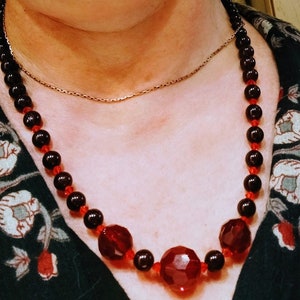 Vintage necklace in glass garnet beads 0.75 and 0.5cm diameter with three faceted red glass beads accentuated in  middle of the necklace