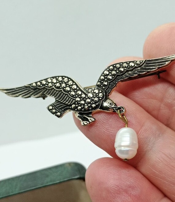 Eagle brooch with pearl on sale