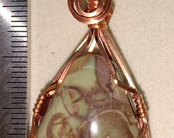 May include: A handcrafted pendant featuring a teardrop-shaped stone with green and brown patterns, encased in copper wire. The pendant is suspended from a copper wire bail. The number "364" is visible in red.