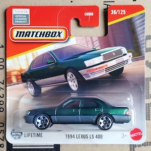 May include: A Matchbox die-cast model of a 1994 Lexus LS 400 in green and gray. The packaging includes the Toyota official licensed product logo and the Matchbox logo. The model is part of the 36/125 series.