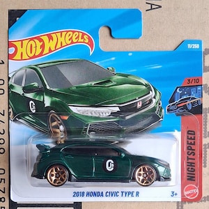 Könnte beinhalten: Ein grünes 2018 Honda Civic Type R Druckguss-Spielzeugauto mit goldfarbenen Rädern. Das Auto befindet sich auf einer blau-weißen Hot Wheels-Karte. Die Karte trägt den Text "NIGHTSPEED" und "3+".