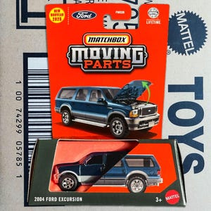 May include: A Matchbox Moving Parts 2004 Ford Excursion toy car on a red and green cardboard package. The blue SUV has its hood open, revealing the engine. The package includes the Ford logo and the text "NEW NOUVEAU 2025".