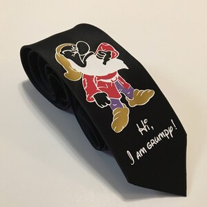 May include: Black tie with a white cartoon image of a grumpy dwarf with the text "Hi, I am Grumpy!"