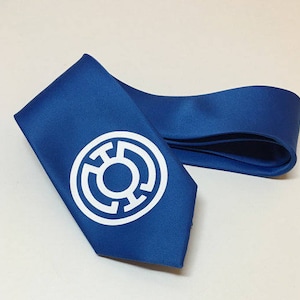 May include: A blue silk tie with a white Green Lantern symbol.