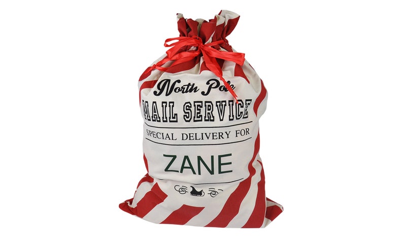 May include: A red and white striped Santa sack with the text "North Pole Mail Service" and "Special Delivery For Zane".