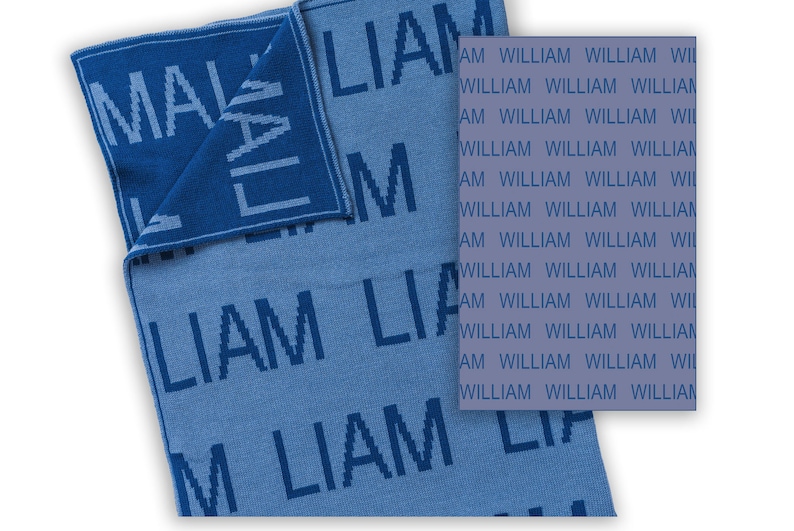 May include: A blue knitted baby blanket with the name "Liam" woven into the fabric. The blanket is reversible, with the name "Liam" on one side and the name "William" on the other side.