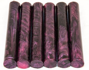 May include: Six round pen blanks in a dark purple and pink marbled pattern with silver glitter.