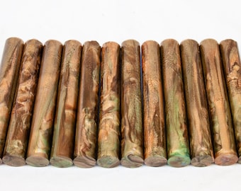 May include: A set of 14 brown and green acrylic pen blanks with gold flecks. The blanks are arranged in a row and have a marbled appearance.