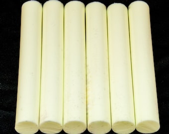 May include: Six off-white cylindrical chalk sticks.