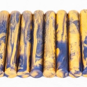 May include: A set of ten yellow and blue marbled acrylic pen blanks. The blanks are approximately 5 inches long and 1/2 inch in diameter.
