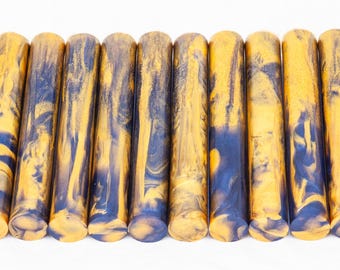 May include: A set of ten yellow and blue marbled acrylic pen blanks. The blanks are approximately 5 inches long and 1/2 inch in diameter.