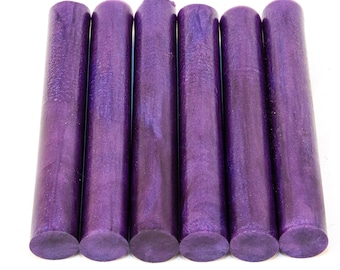 May include: Six purple and iridescent acrylic pen blanks, each with a slightly different pattern and shimmer.