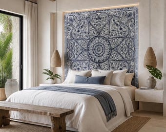 May include: A bedroom featuring a large blue and white patterned tile mural behind a bed with white linens, a blue throw blanket, and blue accent pillows. The room includes two hanging woven pendant lights and a wooden bench at the foot of the bed.