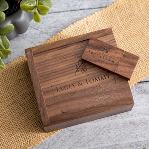 May include: A wooden box with a USB drive inside. The box and drive are engraved with the text "Emily & Tommy 09.23.2018".