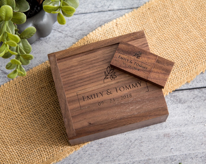 May include: A wooden box with a USB drive inside. The box and drive are engraved with the text "Emily & Tommy 09.23.2018".