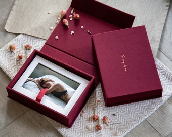 May include: A burgundy fabric-covered box with a white matted photo inside. The box has a gold inscription that reads "To my love".