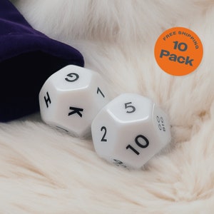 May include: Two white dice with black numbers. The dice are on a white fluffy surface. The dice show the numbers 2, 5, 9, 10, K, and H.