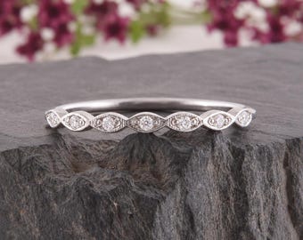 May include: A silver-coloured metal ring featuring a series of marquise-shaped settings along the band. Each marquise shape contains a small, round, clear stone, with delicate milgrain detailing bordering the edges of the metal settings.