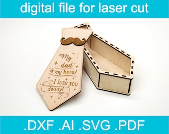 May include: A wooden tie-shaped box with a laser-cut design. The box is open and the inside is visible. The box has the text "My dad is my hero! I love you daddy!" engraved on it.