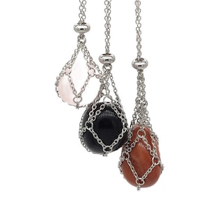 May include: Three silver chain necklaces with different coloured gemstones hanging from them. The gemstones are pink, black, and orange.